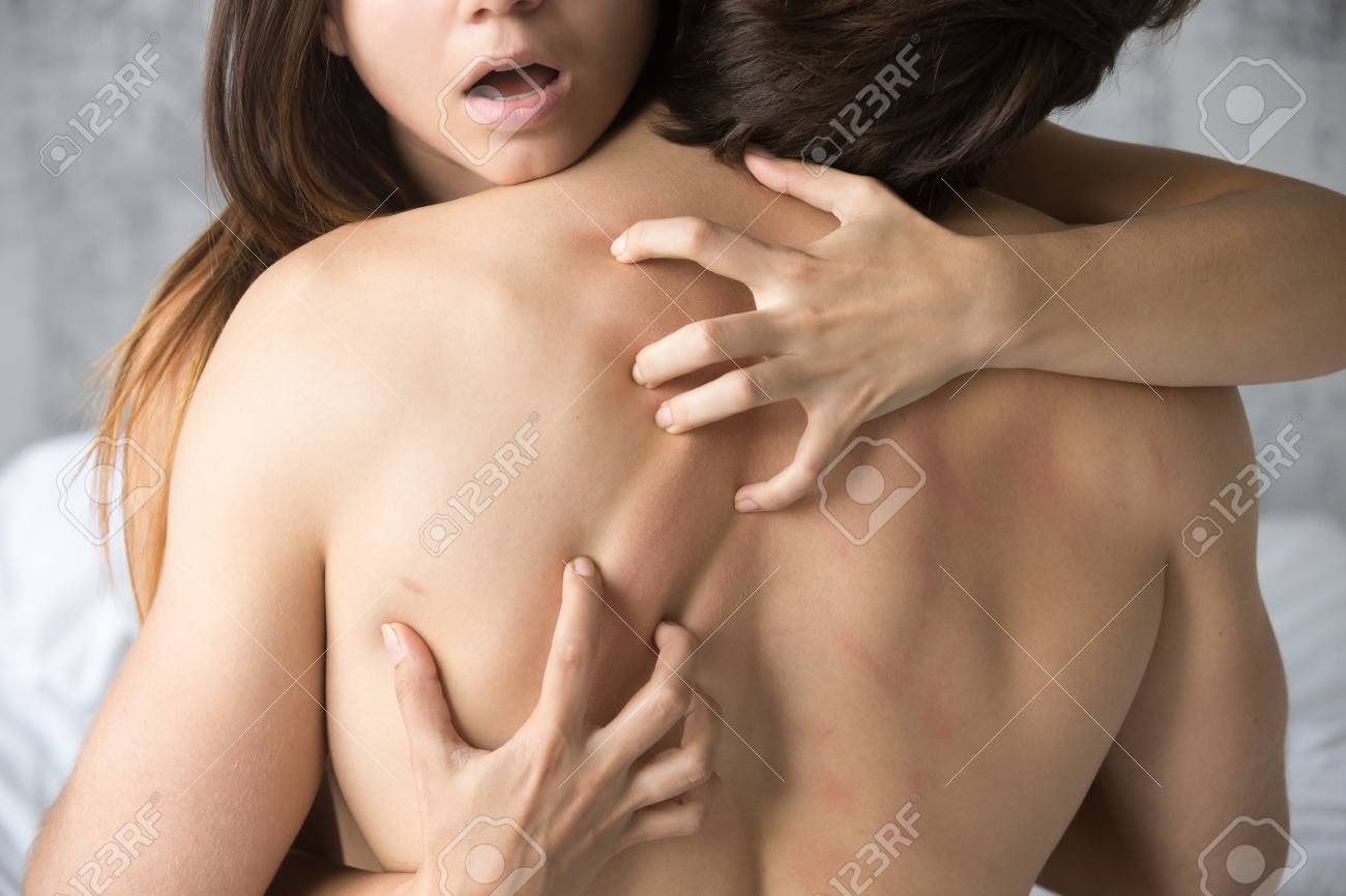 Passionate Horny Woman Scratching Lovers Back Feeling Pleasure Having Sex Sensual Girl Moaning With Desire Caressing Embracing Boyfriend Sitting On Top During Foreplay Or Making Love Close Up View Stock Photo Picture