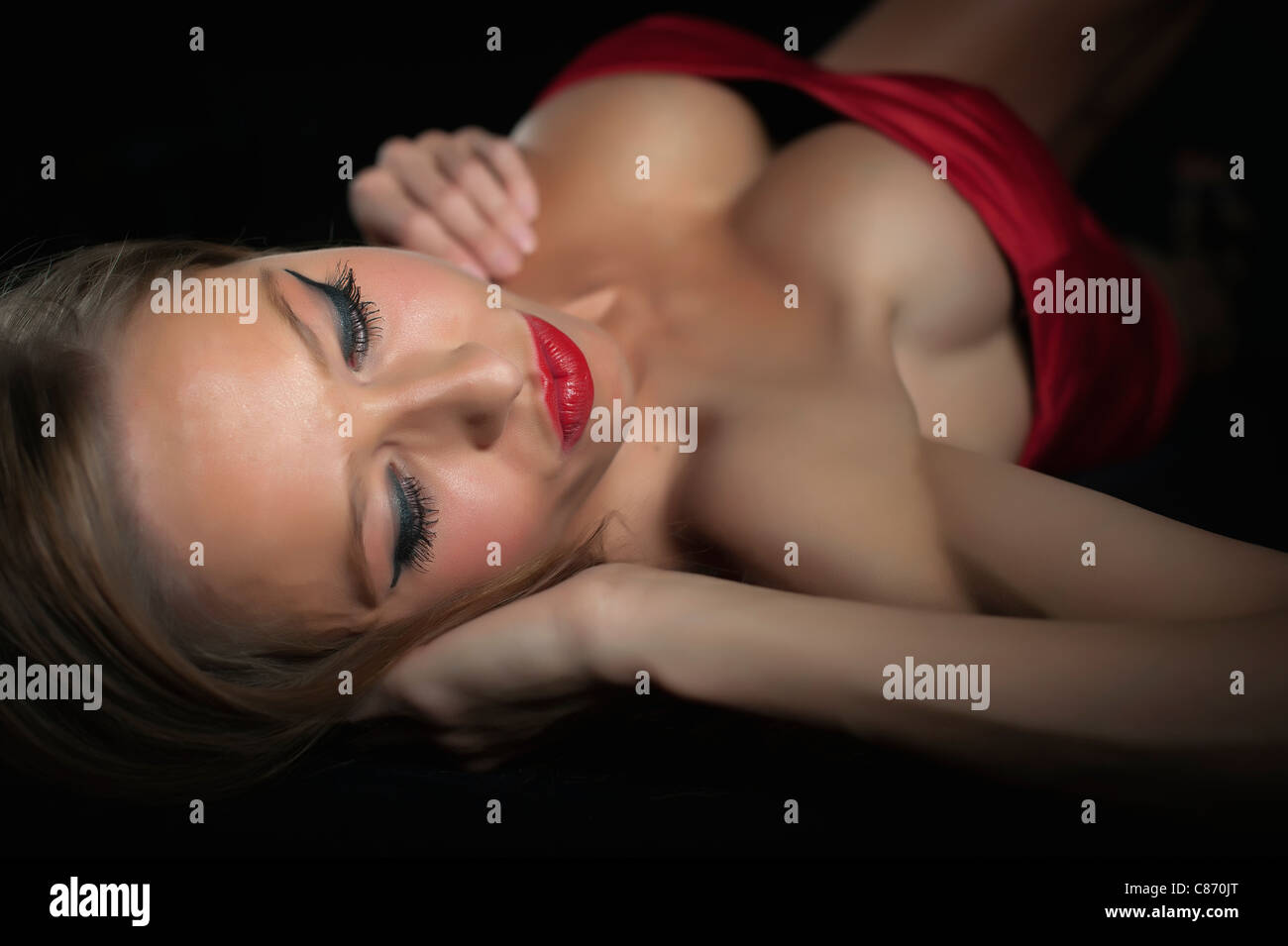 Sexy woman with big boobs lying on her back Stock Photo