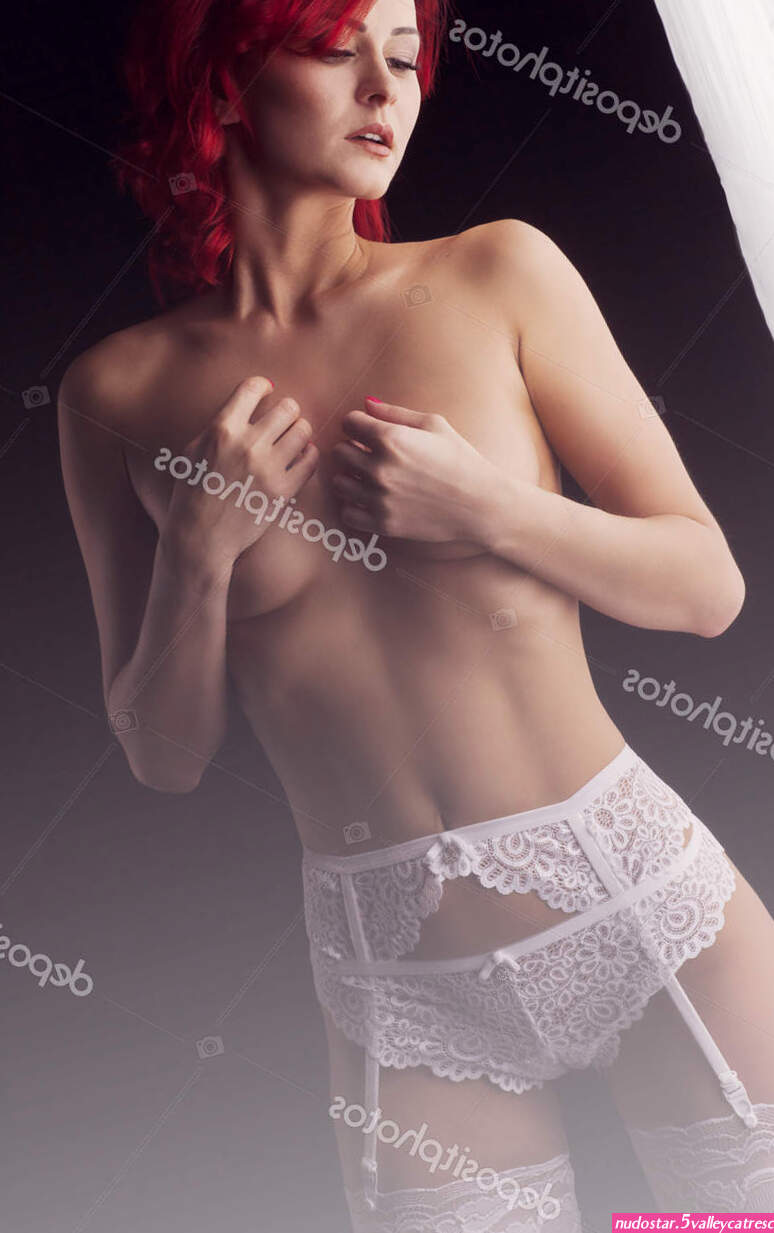 Sexy beautiful redhead woman in white lingerie topless covering boobs with hands Stock Photo fenixlive 157775108
