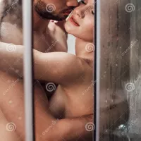 Passionate Naked Couple Hugging and Kissing while Stock Photo