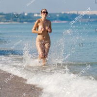 Naked Woman Running Along Beach Stock-foto 58264876