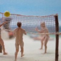 Naked men playing volleyball on the nudist beach.