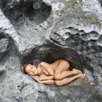 Nude Woman Sleeping on Rock. Stock Photo