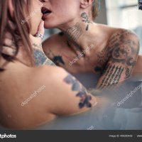 Young Sexy Tattooed Lesbian Couple Having Sex While Enjoying Bath Stock Photo luckybusiness 450293432