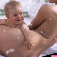 Mother baby in the nude woman lie back view summer child small 5 months infant smile shell contact together happily happily curled inside conception childhood love suture security affection care allowance closeness